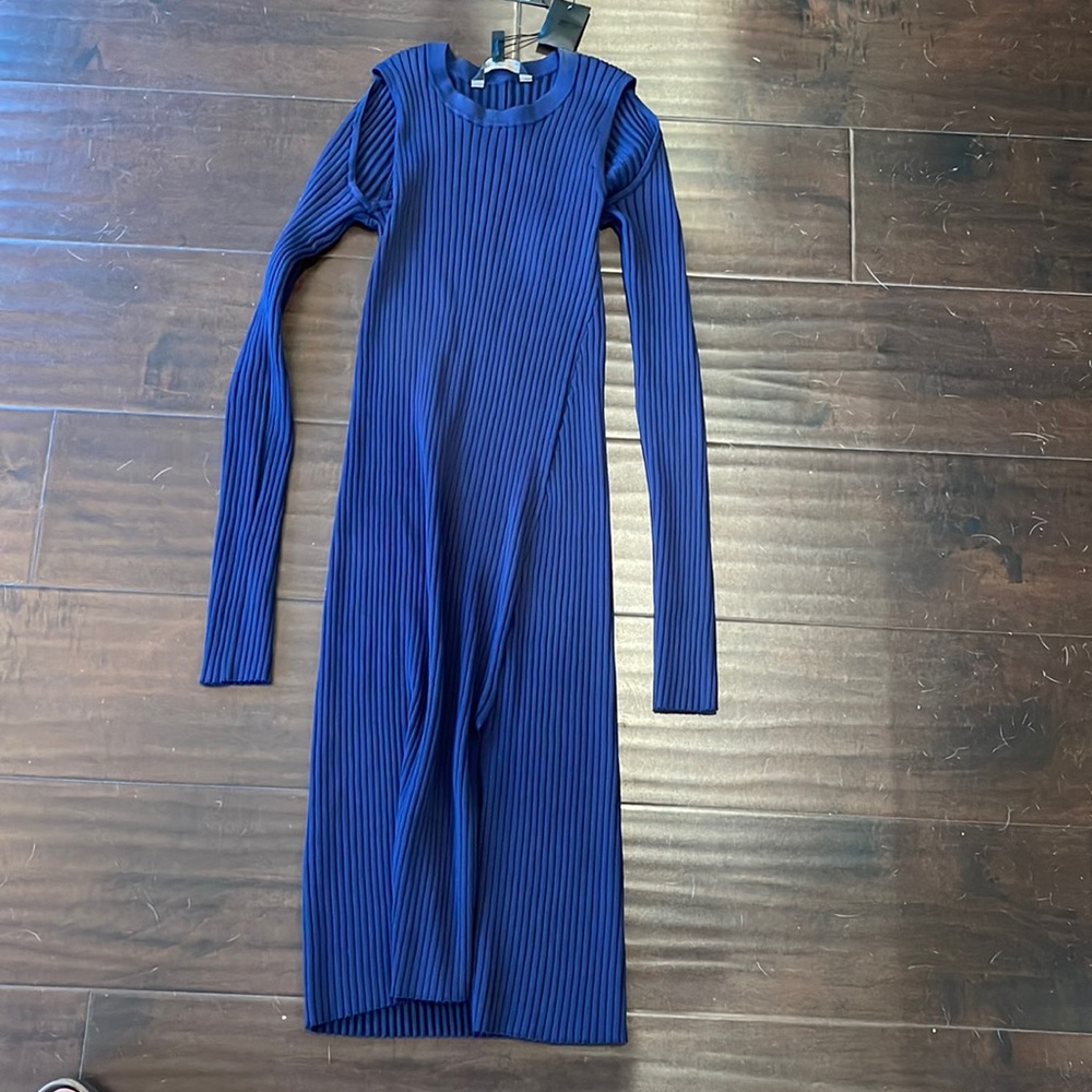 BCBG mid length body on dress with slit and cut outs in the shoulder.